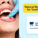 Create a wide 16:9 high-resolution dental infographic for an English healthcare article about safe temporary toothache relief. On the left side, present three connected ultra-realistic photographic scenes in a clean and organised composition: 1. A clear glass containing warm salt water beside a small spoon of salt, representing a salt water rinse. 2. A patient holding a cold compress wrapped in a clean towel against the outside of the cheek. 3. A small unbranded amber bottle of clove oil beside a carrier oil and a clean cotton swab, clearly suggesting proper dilution before use. Keep the patient’s face partially cropped and do not show the full face. All hands, objects, proportions, and dental details must appear realistic. The remedies should look supportive and temporary, not like guaranteed cures. On the right side, create a modern medical infographic layer using soft blue and light-blue panels. Add a large yellow rounded title box displaying exactly: “Safe Toothache Home Treatments” At the bottom right, add an elegant white rounded branding panel containing a blue and teal dental logo, the Arabic brand name “طبيبي”, the English brand name “tbeby”, and the website address “[www.tbeby.com”](http://www.tbeby.com”). Ultra-realistic healthcare photography, bright clean lighting, crisp focus, premium clinical design, trustworthy dental education style, balanced spacing, cohesive blue, white, teal, and yellow colour palette, magazine-quality website infographic. Do not add instructions, labels, numbers, medical claims, or any text other than the specified title and branding. No raw garlic touching the gums, no undiluted essential oil application, no ice directly on the skin, no blood, no pills, no exaggerated swelling, no cartoon style, and no distorted hands or objects.